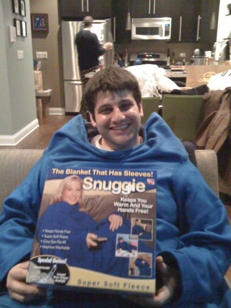 Joshua in his Snuggie with his Snuggie box - he's warm and his hands are indeed free to hold that box. He couldn't do that in a regular blanket.